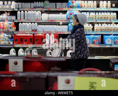 --FILE--un client chinois pousse un panier passé le lait et autres produits laitiers à un supermarché de la ville de Qiqihar, nord-est de l'Anhui en Chine p Banque D'Images