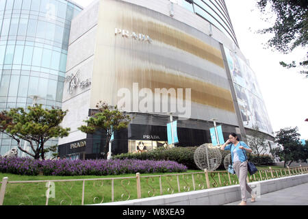 FILE--A pedestrian walks past a fashion boutique of Louis Vuitton (LV) at  the headquarters building of LVMH China, also known as the L'Avenue Shangh  Stock Photo - Alamy