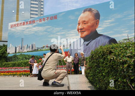 --FILE--touristes posent pour des photos devant un panneau de la fin dirigeant chinois Deng Xiaoping dans la ville de Shenzhen, province de Guangdong, en Chine du sud 2 Banque D'Images