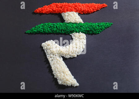 Indian rupee symbol made of rice and representing Indian Flag Stock Photo