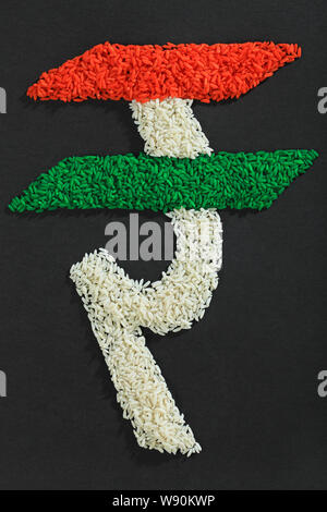 Indian rupee symbol made of rice and representing Indian Flag Stock Photo