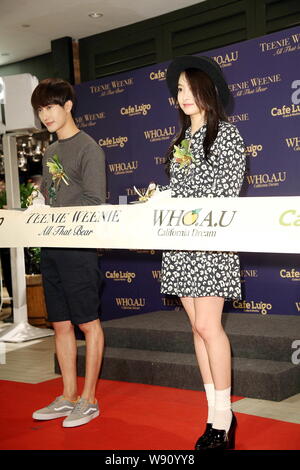 Zhou Mi du groupe sud-coréen Super Junior garçon-M, à gauche, et Victoria Song Qian sud-coréen de pop girl du groupe f(x) ont coupé le ruban lors d'une ouverture ev Banque D'Images