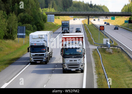 Salo, Finlande. Le 19 juillet 2019. Volvo FH16 platine dépasse deux autres poids lourds Volvo Trucks transport sur route national finlandais, 1 E18, en été. Banque D'Images