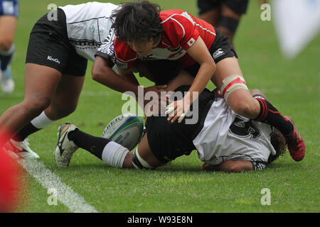 Les joueurs du Japon (rouge) et les Fidji (blanc) lors de leur match au cours de l'IRB Sevens 2013 Womens World Series dans la ville de Guangzhou, Chine du sud Guangdon Banque D'Images