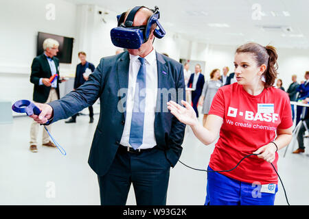 Ludwigshafen, Allemagne. Août 12, 2019. Martin Brudermüller (l), Président du Conseil d'administration de le groupe chimique BASF, essaie de la fonctionnalité de lunettes de réalité virtuelle avec un stagiaire du groupe chimique BASF. Ministre de l'emploi Heil est sur un voyage d'été. Credit : Uwe Anspach/dpa/Alamy Live News Banque D'Images