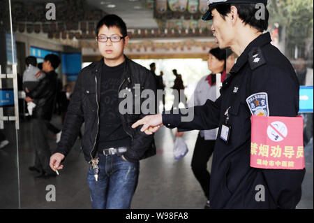 --FILE--un inspecteur chinois essaie de persuader un homme de ne pas fumer dans un hôpital de la ville de Wenling, dans la province du Zhejiang, Chine de l'est 31 mars 2011. Chine Banque D'Images