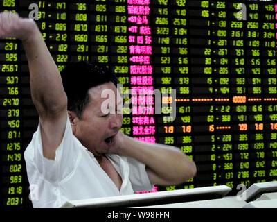 Un investisseur chinois se penche sur le prix des actions (vert pour la baisse des prix) à une maison de courtage de l'est de Hangzhou, province de Zhejiang, Chine 5 Septembre Banque D'Images