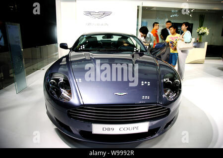 --FILE--visiteurs regarder l'Aston Martin DB9 Coupé au cours d'une auto show à Chongqing, Chine, 12 juin 2010. Dernières nouvelles une année record où Aston Ma Banque D'Images