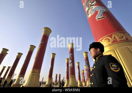 Les résidents chinois passent devant les colonnes de l'unité nationale dans le Parc olympique de Beijing, Chine, 1 février 2010. Les colonnes de l'unité nationale 56 Banque D'Images