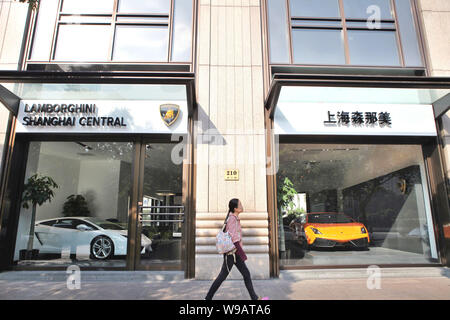 Une femme chinoise marche dernières du nouveau concessionnaire de Lamborghini à Shanghai, Chine, le 9 novembre 2010. Automobili Lamborghini SpA a ouvert deux nouveaux courtiers Banque D'Images