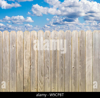 Clôture en bois blanchi rustique avec ciel bleu et nuages Banque D'Images