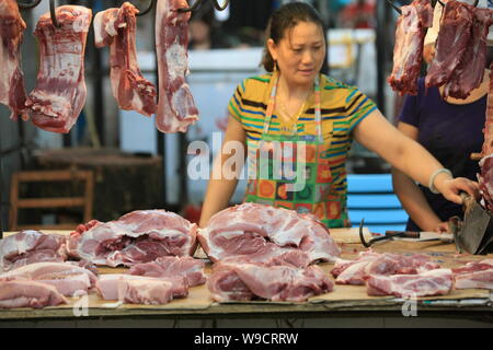 --FILE--Un vendeur vend chinois au porc un marché libre à Shanghai, Chine, le 6 août 2009. La Chine s'était engagée à lever son embargo sur le porc des États-Unis le jeudi (29 O Banque D'Images