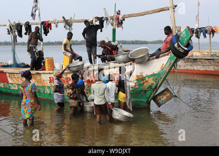 Les femmes achètent le poisson à Ada Foah, au Ghana. La pêche illégale par des navires étrangers menace les villages de pêcheurs traditionnels au Ghana. Banque D'Images