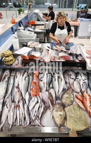 PORTO, PORTUGAL - 24 MAI 2018 : vendeur à un stand de poisson dans Mercado do Bolhão, Porto. Mercado do Bolhão est un marché traditionnel place. Banque D'Images