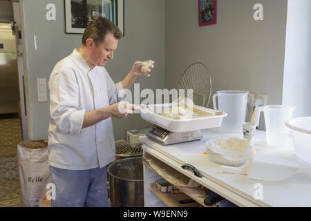 Le boulanger de la Boulangerie des roses en Chedigny, France. Le boulanger est vu préparer la pâte pour un lot de pain. Banque D'Images