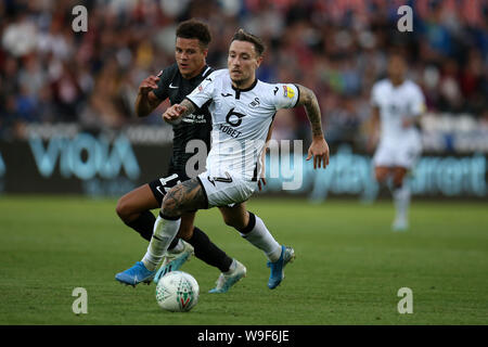 Swansea, Royaume-Uni. Août 13, 2019. Barrie McKay de Swansea City va passé Shaun McWilliams de Northampton Town. Carabao tasse tasse EFL, 1er tour, match Swansea City v Northampton Town au Liberty Stadium de Swansea, Pays de Galles du Sud le mardi 13 août 2019. Cette image ne peut être utilisé qu'à des fins rédactionnelles. Usage éditorial uniquement, licence requise pour un usage commercial. Aucune utilisation de pari, de jeux ou d'un seul club/ligue/dvd publications. Photos par Andrew Andrew/Verger Verger la photographie de sport/Alamy live news Crédit : Andrew Orchard la photographie de sport/Alamy Live News Banque D'Images