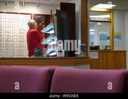 Wallingford, CT USA. Aug 2019. Un homme âgé à la recherche à la sélection de lunettes à la clinique des soins des yeux. Banque D'Images