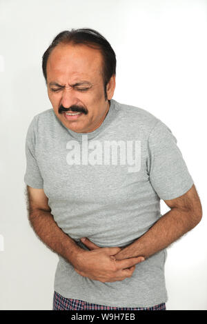 Mature man suffering from abdominal pain Stock Photo