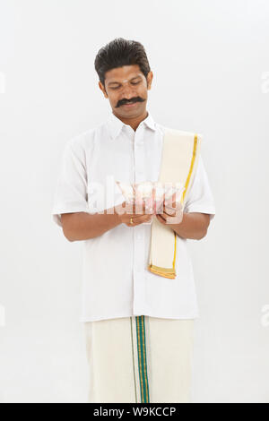 South Indian man counting thousand rupees banknotes Stock Photo