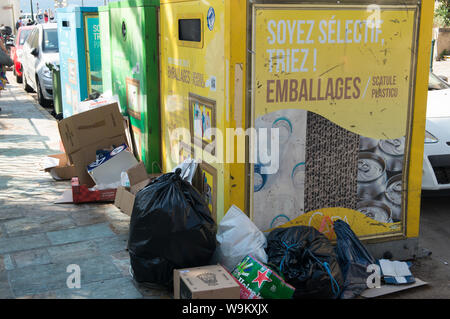 Ajaccio, Corse, 2019-08-France.. Plus de bacs remplis de recycler des sacs avec de la rue sur le trottoir Banque D'Images