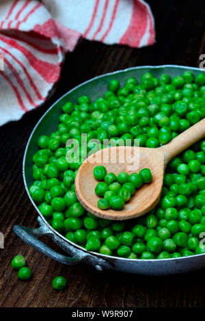 Aufgetaute gruene Erbsen Kochloeffel de Schale mit, Pisum sativum Banque D'Images