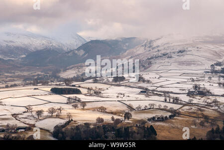 La neige se trouve sur des champs sur les pentes du cercle de pierres de Castlerigg est tombé dans l'Angleterre du Lake District. Banque D'Images