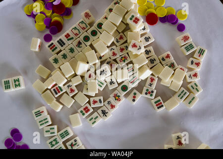 Tuiles de Mahjong (majong) et plaquettes sont dispersés sur une table à Port Dickson, Malaisie. Banque D'Images