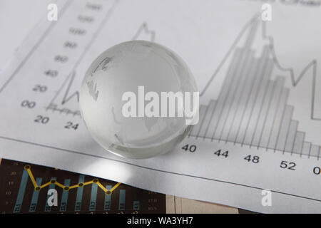 Close up of a globe with bar graphs Stock Photo
