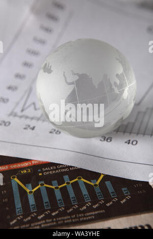Close up of a globe with bar graphs Stock Photo