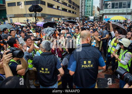 Hong Kong, Chine. Août 17, 2019. Deux policiers sont entourés par les manifestants et les représentants de la presse au cours d'une démonstration. Nouveau week-end de protestation à Hong Kong : des dizaines de milliers de partisans de la démocratie tirez à nouveau à travers la ville. Et en ce dimanche (18.08.2019) il y en aura encore plus. Credit : Gregor Fischer/dpa/Alamy Live News Banque D'Images