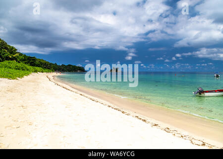 Paradise beach anse royale sur l'île de Mahé aux Seychelles avec turguoise l'eau, de palmiers, de sable blanc et de rochers de granit Banque D'Images