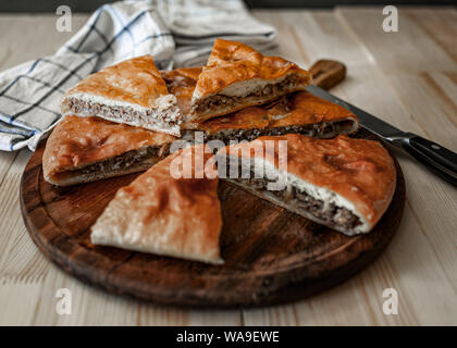 Ossètes traditionnels pâtés à la viande de boeuf sur un fond de bois. De style rustique, Close up, selective focus Banque D'Images