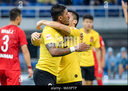 Joueur de football brésilien Paulinho, gauche, de Guangzhou Evergrande Taobao célèbre avec son coéquipier après avoir marqué contre Tianjin Tianhai dans leurs 1 Banque D'Images