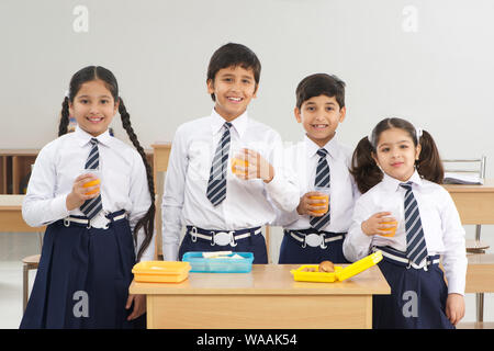 Students drinking juice in lunch time Stock Photo