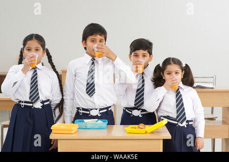 Students drinking juice in lunch time Stock Photo