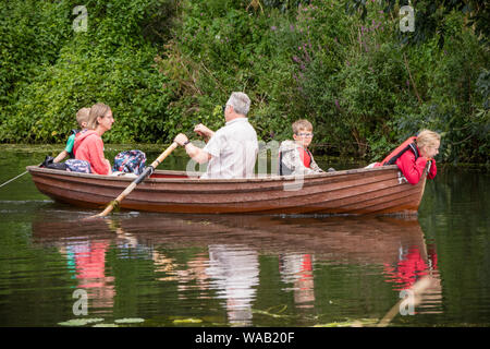 Les visiteurs au moulin de Flatford voitures bateaux à rames pour explorer la rivière Stour, Dedham Vale, Suffolk, Angleterre, RU Banque D'Images