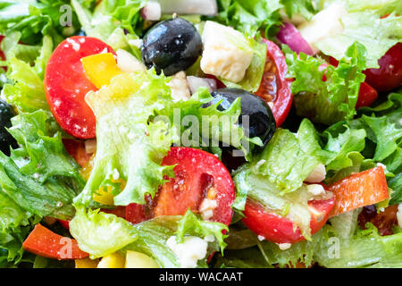 Vue panoramique de salade grecque de légumes frais, fromage feta et olives noires habillées par l'huile d'olive close-up Banque D'Images