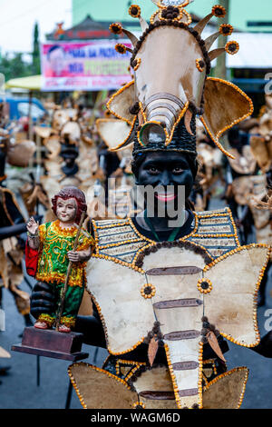 Des gens habillés en costume Tribal parade dans les rues de Kalibo Holding Santo Nino Statues, le Festival Ati-Atihan, Kalibo, Philippines Banque D'Images