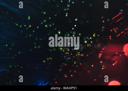 Beau vert, bleu, rouge sur un arrière-plan flou d'éclat. Banque D'Images