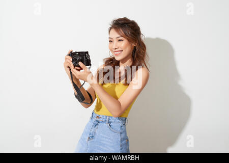 Young Pretty woman holding digital camera Banque D'Images