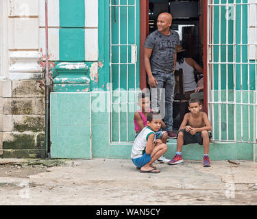 La Havane, Cuba - 09 avril, 2019 : un homme et trois enfants à l'entrée d'un appartement Banque D'Images