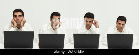 Les hommes d'affaires travaillant sur un ordinateur portable et pensant Banque D'Images