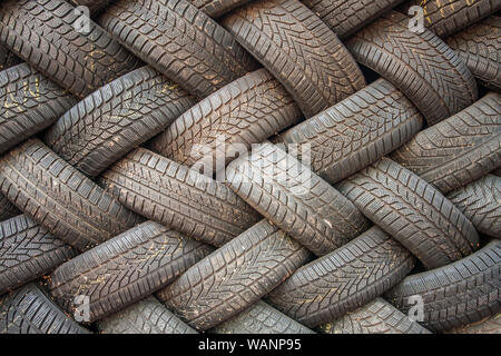 Contexte, la texture du mur de pneus mis à un angle. Caoutchouc de pneu noir, pièce du véhicule, pièce de rechange. Banque D'Images