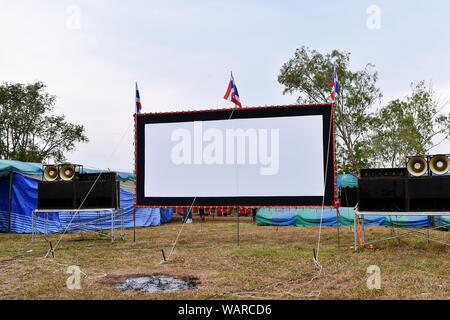 Outdoor écran de cinéma et un système de son sur le terrain ouvert dans le temple festival. Thaïlande Banque D'Images