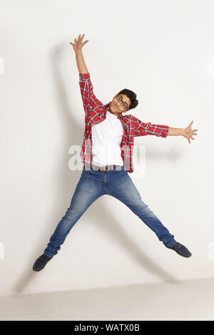 College student jumping in mid air Stock Photo