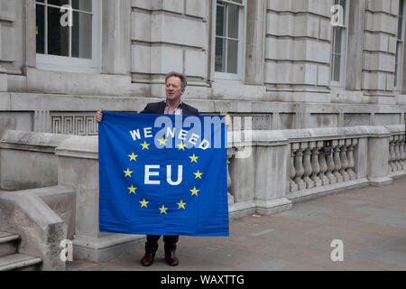 Avec un manifestant anti Brexit drapeau de l'Union européenne lecture nous avons besoin à l'extérieur de l'UE Le bureau du Cabinet dans la région de Westminster comme à l'intérieur du Cabinet conservateur se réunit pour discuter des Brexit le 16 août 2019 à Londres, Angleterre, Royaume-Uni. Banque D'Images