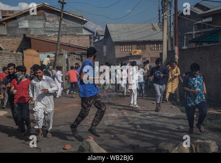 Srinagar, au Cachemire sous contrôle indien. Août 23, 2019. Les protestataires Kashmiri Run for Cover comme police indienne les chasser durant une manifestation dans la ville de Srinagar, la capitale d'été du Cachemire sous contrôle indien, le 23 août 2019. Le Cachemire sous contrôle indien agitée a continué à rester au secret vendredi pour la 19e journée consécutive. Les autorités soumettant à des restrictions en raison de l'appel de séparatistes de mars le Groupe des observateurs militaires des Nations Unies pour l'Inde et le Pakistan (UNMOGIP) dans la ville de Srinagar. Credit : Javed Dar/Xinhua/Alamy Live News Banque D'Images