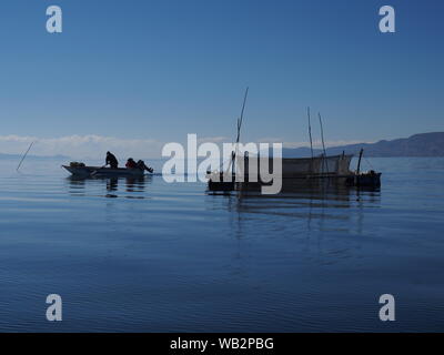 Lever du soleil dans un élevage de truite flottante sur le lac Titicaca. Le Uru ou Uros sont un peuple autochtone du Pérou et de la Bolivie, qui vivent sur une centaine d'îles flottantes, faites de Totora Reed, dans le lac Titicaca près de Puno. Banque D'Images