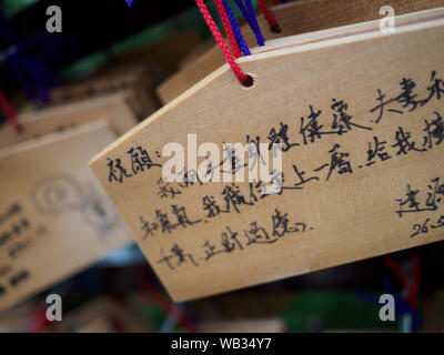 Plaques en bois Ema avec prières écrites étendus dehors un sanctuaire shinto à Tokyo, Japon. Banque D'Images