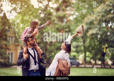 Les parents d'heureux avec leur fille après l'école Banque D'Images